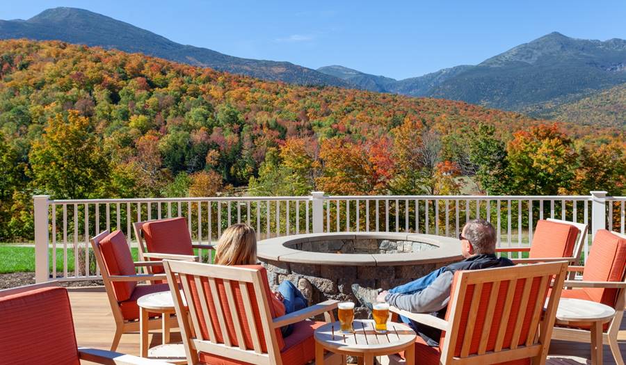 Outdoor Fire Pit with Two People Viewing the Fall Colors on Mount Washington